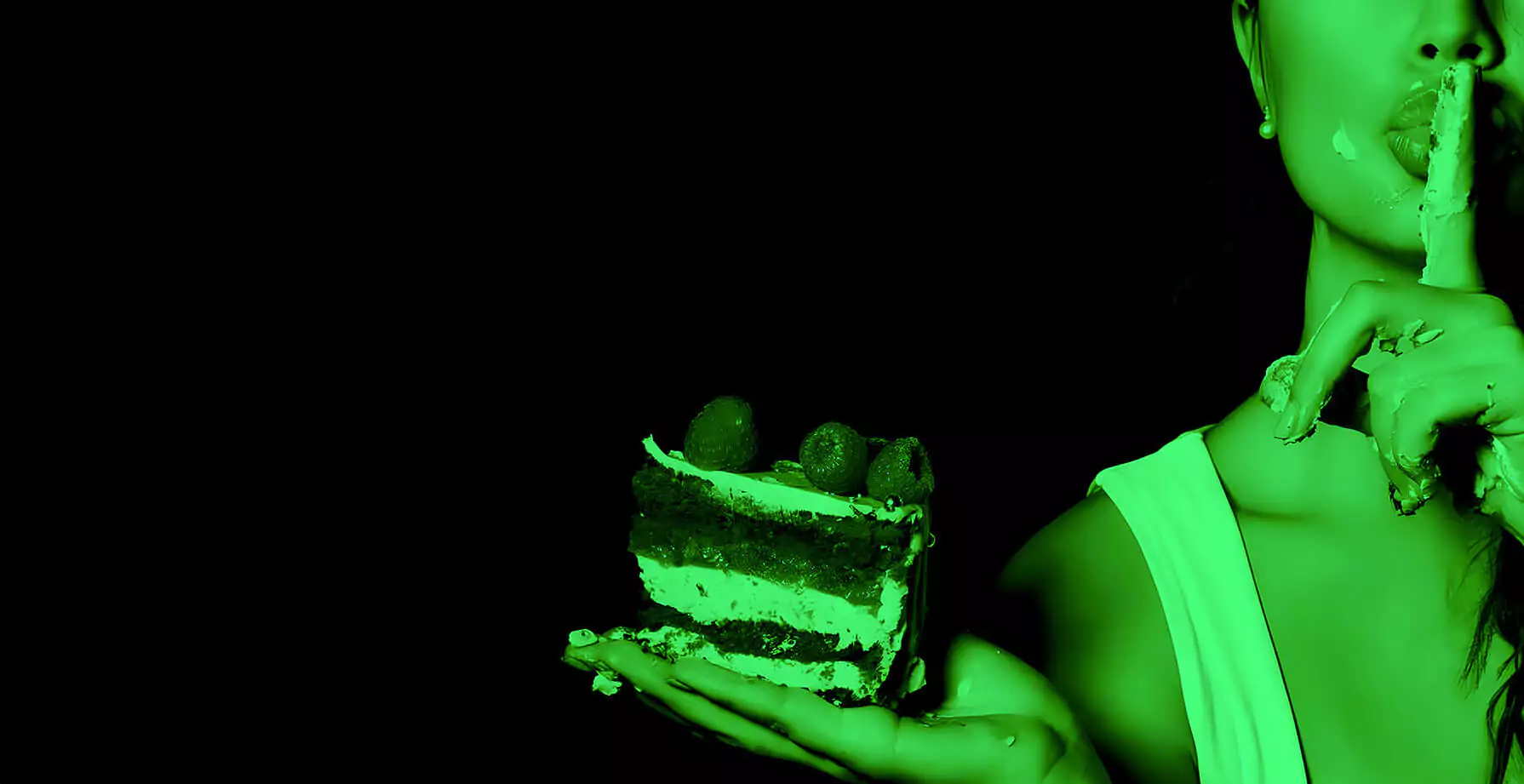 Woman holding slice of cake, whispering